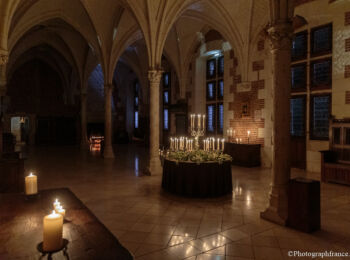 Grande salle du château d'Amboise éclairée à la lumière des chandelles